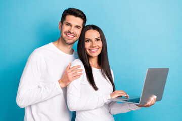 Photo portrait of cute young man woman hold laptop ecommerce booking tickets dressed stylish white outfit isolated on blue color background