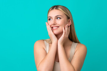 Wall Mural - Portrait of pretty young woman over blue isolated background