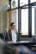 Happy excited successful business asian woman triumphing in office, Portrait of a cheerful Asian businesswoman sitting at the table in office, 