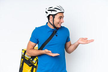 Wall Mural - Young caucasian man with thermal backpack isolated on white background with surprise facial expression