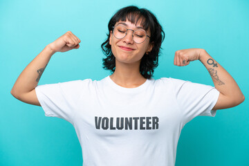 Wall Mural - Young volunteer Argentinian woman isolated on blue background doing strong gesture