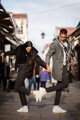 Multiracial couple posing on narrow streets in old part of the sity. Old turkish bazaar in Skopje, North Macedonia.