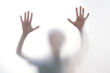 © volurol - Silhouette scared boy stand behind glass door. Kid showing two hands.