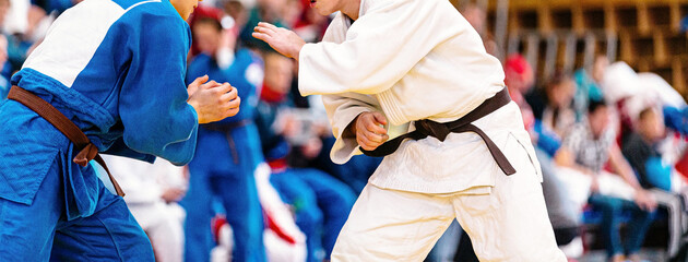 fight of two judoka athletes in judo competition