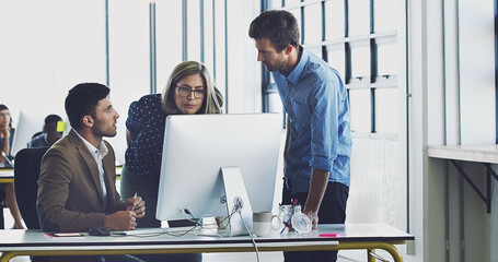 Collaboration, management and team working together on a web design at a startup company office using internet. Group, teamwork and business people using computer for developers of idea