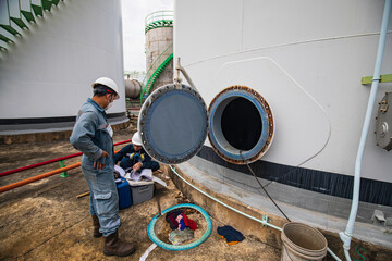 Male worker into the tank carbon chemical oil interface area confined space