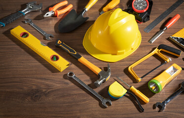 Wall Mural - Work tools with helmet on wooden background.