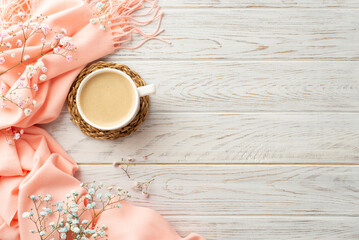 Hello spring concept. Top view photo of cup of coffee on rattan serving mat gypsophila flowers and pink plaid on grey wooden desk background with copyspace