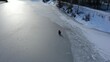 Winter fishing on melted ice from a bird's eye view. Risky winter fishing. Fishermen sit on blue and gray ice with fishing rods.