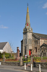 Wall Mural - Entrance Gate Spire and Clock on Old Victorian Stone Church against Blue Sky