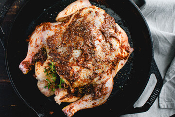 Sticker - Raw Chicken Covered with Apple Butter Glaze: Raw roaster covered with a spice glaze in a cast iron skillet