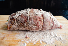 Prepped Stuffed Flank Steak Dusted In Flour: Raw Beef Pounded Thin, Stuffed With Filling, And Tied With Kitchen String