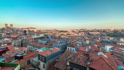 Wall Mural - Sunset time, shadow covering Douro riverside with the Dom Luiz bridge and Mosteiro da Serra do Pilar, Porto aerial panoramic timelapse, Portugal. Warm evening light