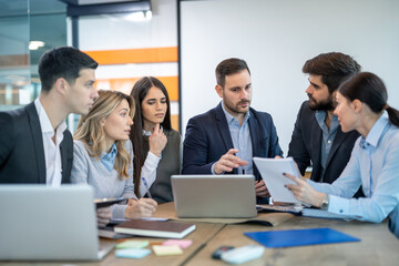 Team of focused business executives analyzing company annual financial report balance together at office. Business, market, office and tax concept.