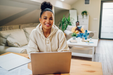 Portrait of a hispanic woman using laptop at home