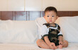 © samurai - Cute little baby sitting bedroom