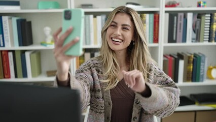 Sticker - Young blonde woman student having video call at library university