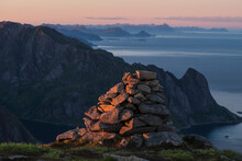 Cairn Stone Heap On Summit Of Veinestind At Sunset