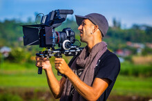 A Cameraman Holding Camera In Bali,Indonesia.