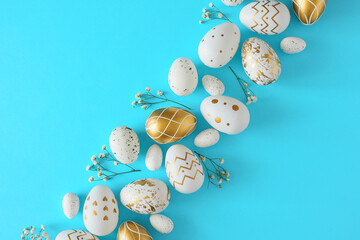 Wall Mural - Hello concept. Flat lay composition made of white and gold eggs with gypsophila flowers on pastel blue background. Easter holiday card idea.