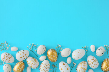 Wall Mural - Hello Easter concept. Flat lay photo of white and gold eggs with gypsophila flowers on pastel blue background with empty space. Easter invitation card idea.