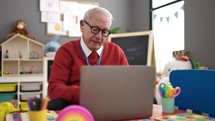 Poster - senior preschool teacher on a video call at kindergarten