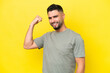 © luismolinero - Young Arab handsome man isolated on yellow background doing strong gesture