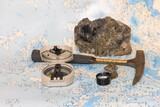 Fototapeta Londyn - Geological fieldwork tools: hammer, compass, magnifying glass, rock samples, topographic and geological maps