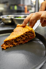 Sticker - chef hand cut meat pie on restaurant kitchen