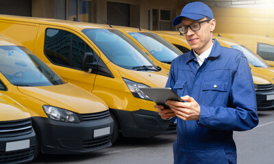 Poster - Manager with a digital tablet on the background of vans. Fleet management