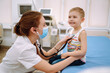 © maxbelchenko - Female Doctor examining a little boy by stethoscope. Сhild's health