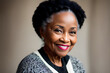 © Dawid - Black senior woman having first grey hair. Smiling at camera. Grey empty background. Generative AI