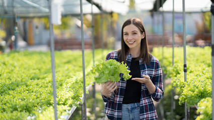 Young caucasian female farmer with Hydroponic organic lettuce and salad plant farm modern agriculture industry..