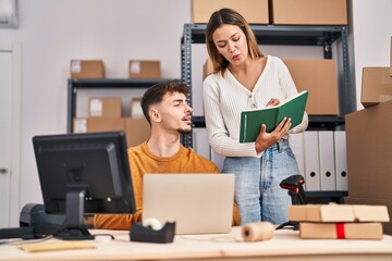 Wall Mural - Young man and woman ecommerce business workers working at office