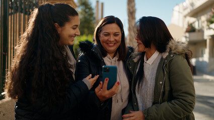 Poster - Mother and daugthers using smartphone standing together at street