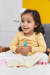 Sticker - Adorable hispanic toddler smiling confident sitting on bed at bedroom