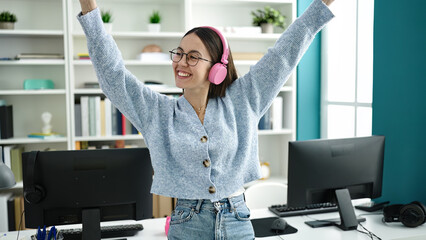 Poster - Young beautiful hispanic woman student listening to music dancing at library university