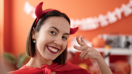 Sticker - Young beautiful hispanic woman wearing devil costume make selfie by camera at home