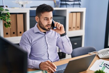 Poster - Young hispanic man business worker talking on the smartphone working at office