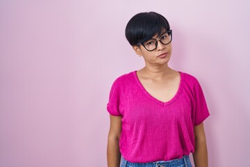 Sticker - Young asian woman with short hair standing over pink background skeptic and nervous, frowning upset because of problem. negative person.