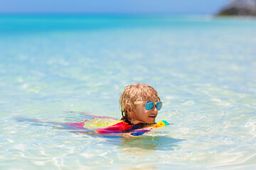 Wall Mural - Kids surf on tropical beach. Vacation with child.