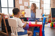 © Krakenimages.com - Teacher and toddler sitting on table having maths lesson at kindergarten