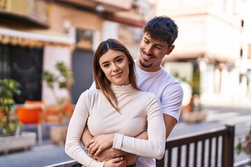 Poster - Mand and woman couple hugging each other at street