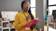 © Krakenimages.com - African woman working as teacher writing on clipboard at kindergarten