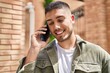 © Krakenimages.com - Young hispanic man smiling confident talking on the smartphone at street