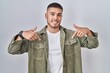 © Krakenimages.com - Young hispanic man standing over isolated background looking confident with smile on face, pointing oneself with fingers proud and happy.