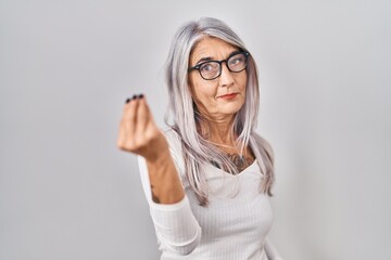 Poster - Middle age woman with grey hair standing over white background doing italian gesture with hand and fingers confident expression