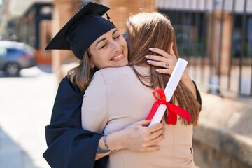 Poster - Mother and daughter hugging each other celebrating graduation at university