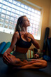 © oscargutzo - caucasian woman sitting in lotus position with closed eyes meditating indoors