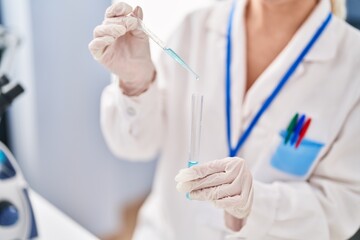 Sticker - Young blonde woman wearing scientist uniform measuring liquid at laboratory